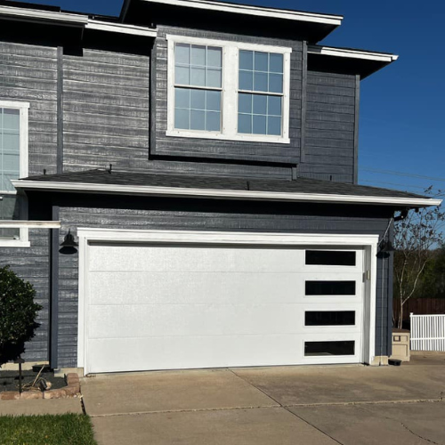 A gray house with a white garage door
