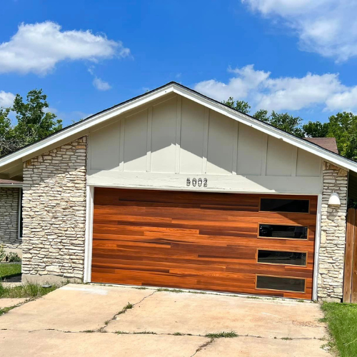A house with a wooden garage door and the number 9002