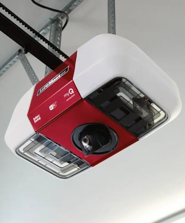 Close-up view of a modern ceiling-mounted garage door opener connected to the rail system inside a residential garage.