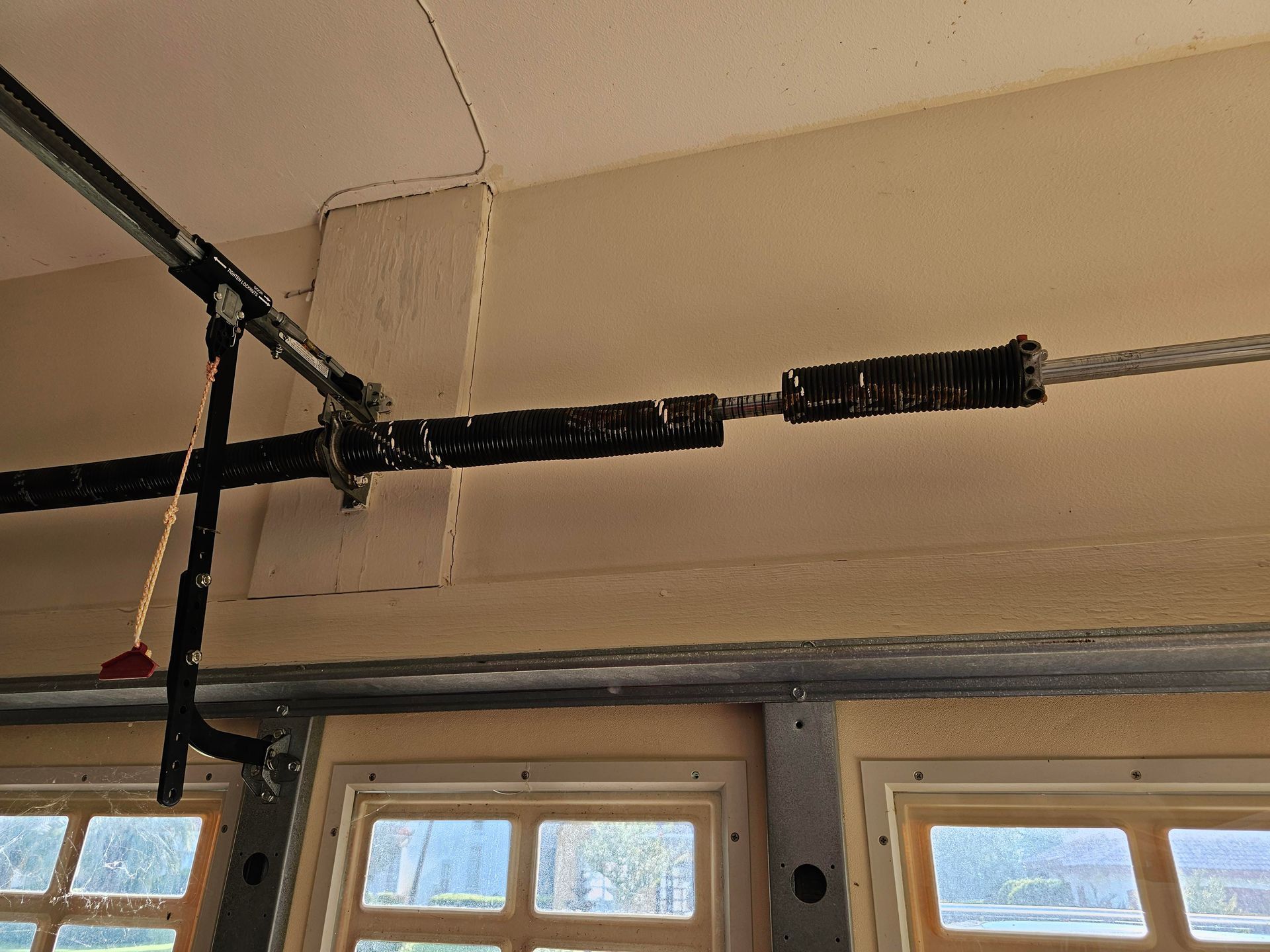 image from a reddit user of a garage door spring that is snapped into two pieces