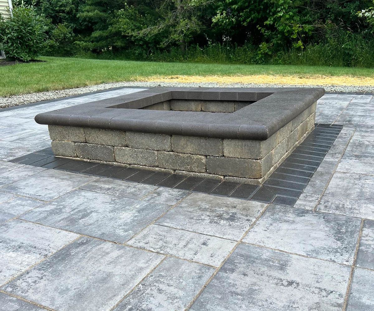 Unilock square fire pit woodburning on Sharon Center, OH backyard paver patio
