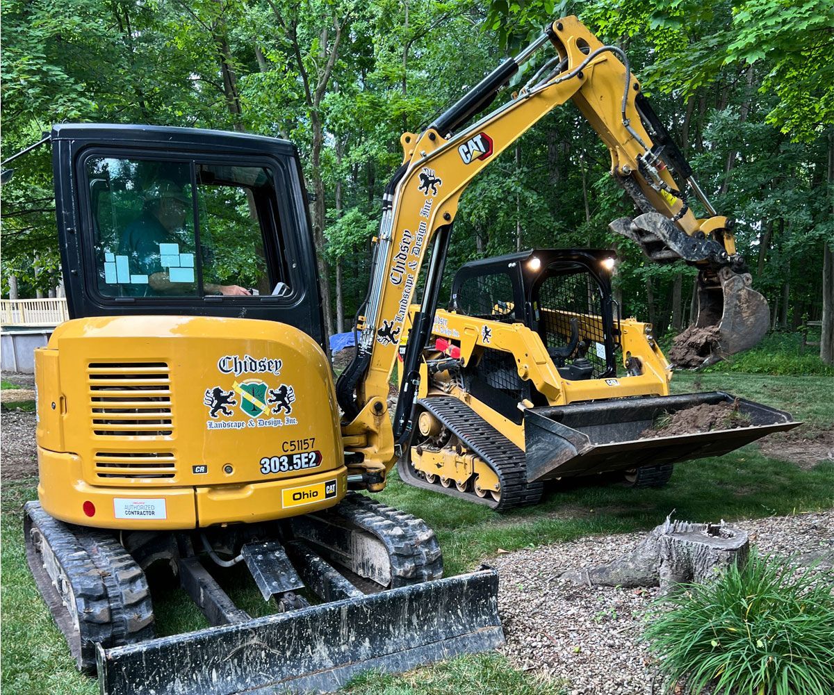 Heavy equipment installing a custom paver patio in Medina, OH for a Chidsey Landscape & Design client