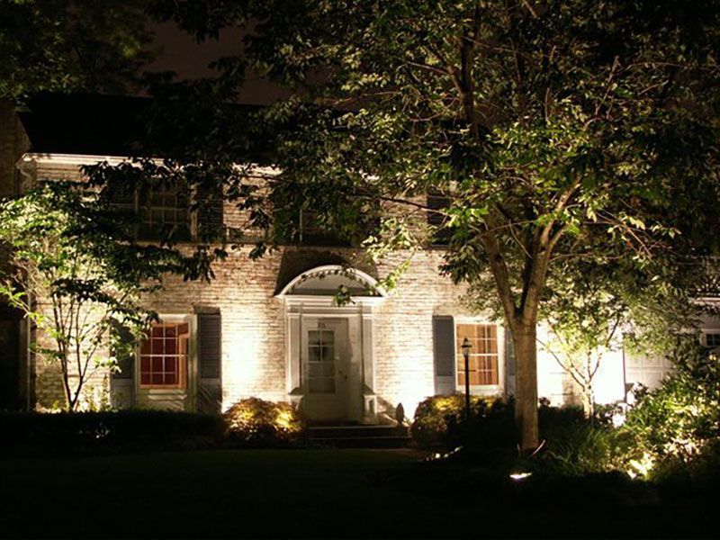 Front of Lorain County, OH home with exterior landscape lighting with tree accent lighting and walkway path outdoor lights