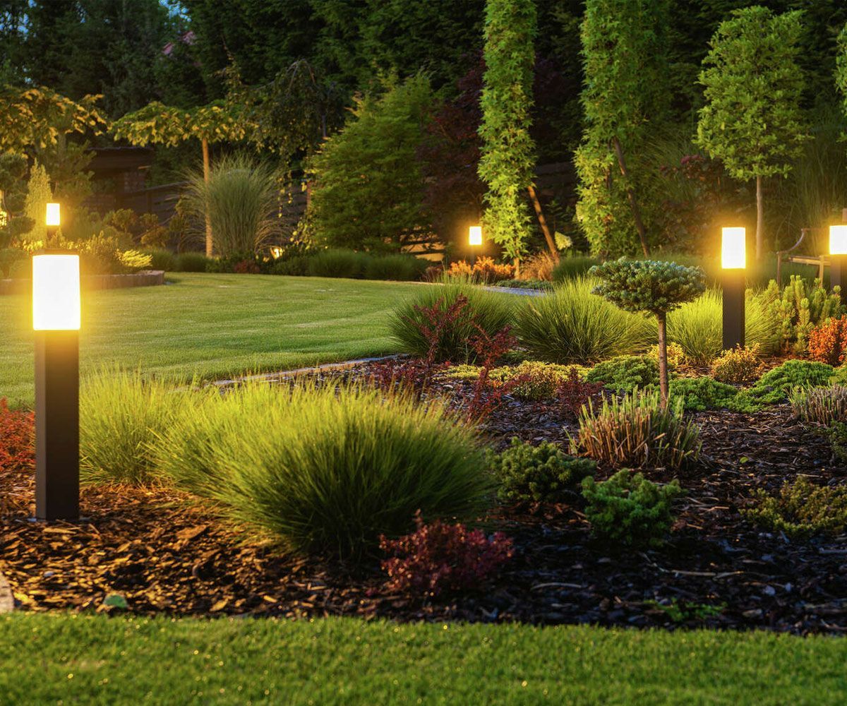 Exterior landscape path lighting lining garden bed of Northeast Ohio backyard installed by Chidsey Landscape & Design