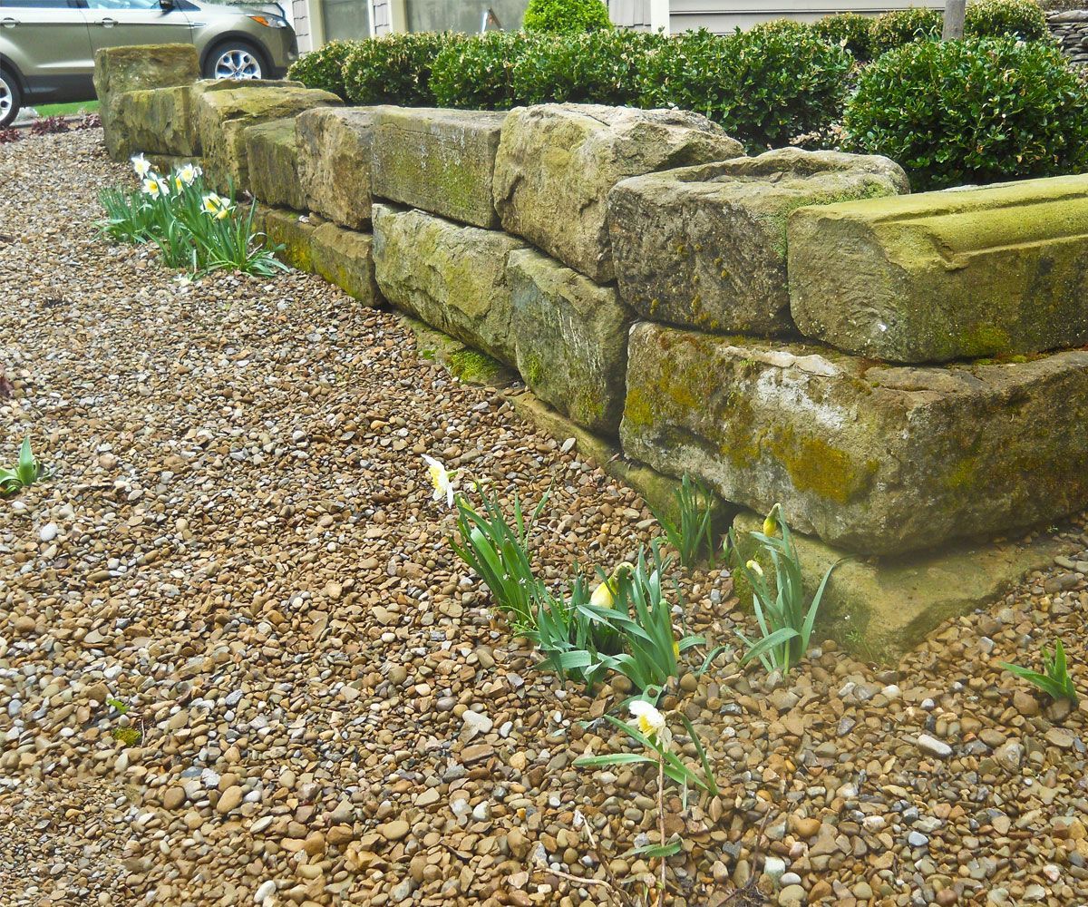 Natural barn stone block wall by Chidsey Landscape & Design in front garden bed of Summit County home
