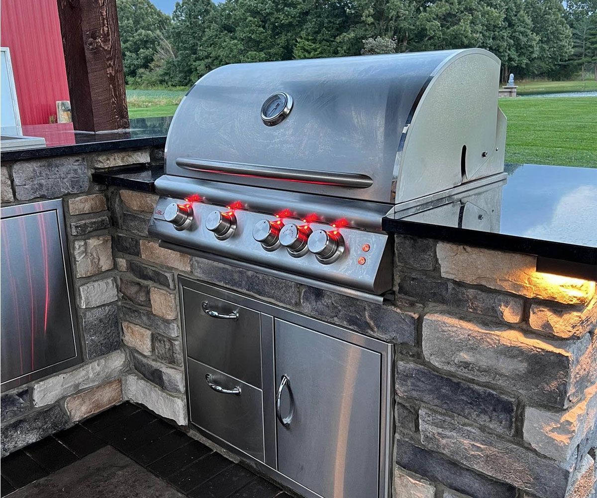 Summit County, OH custom masonry outdoor kitchen with multi-level counters under cedar pavilion by Chidsey Landscape & Design