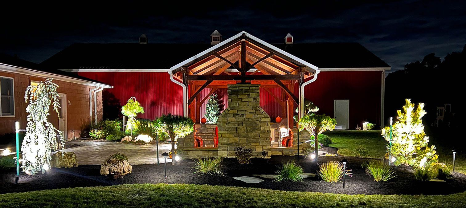 Outdoor living landscape project in Northeast Ohio with exterior landscape lighting in garden beds.
