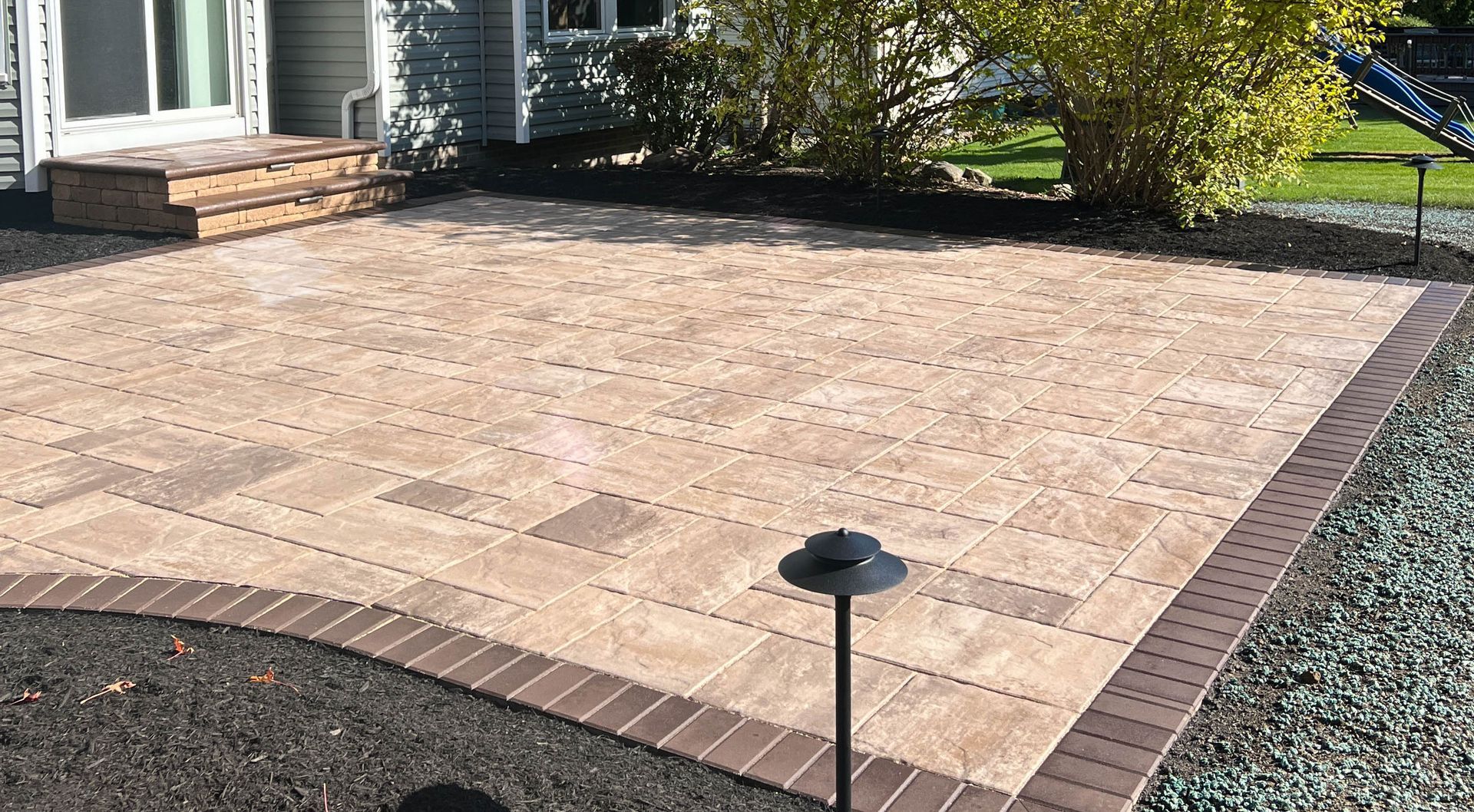 Interlocking paver patio in Northeast Ohio backyard installed by Chidsey Landscape & Design