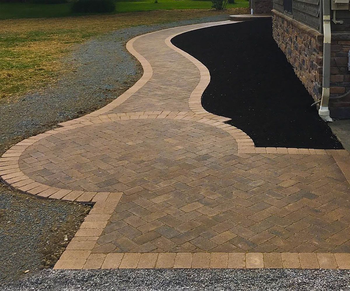 Custom circular paver front entrance of Summit County house with matching border