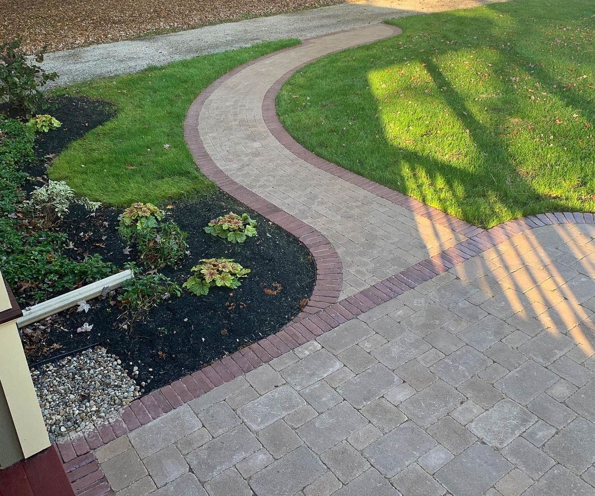 Asymmetrical curved front entrance walkway made with paving stones of Medina, Ohio Victorian house