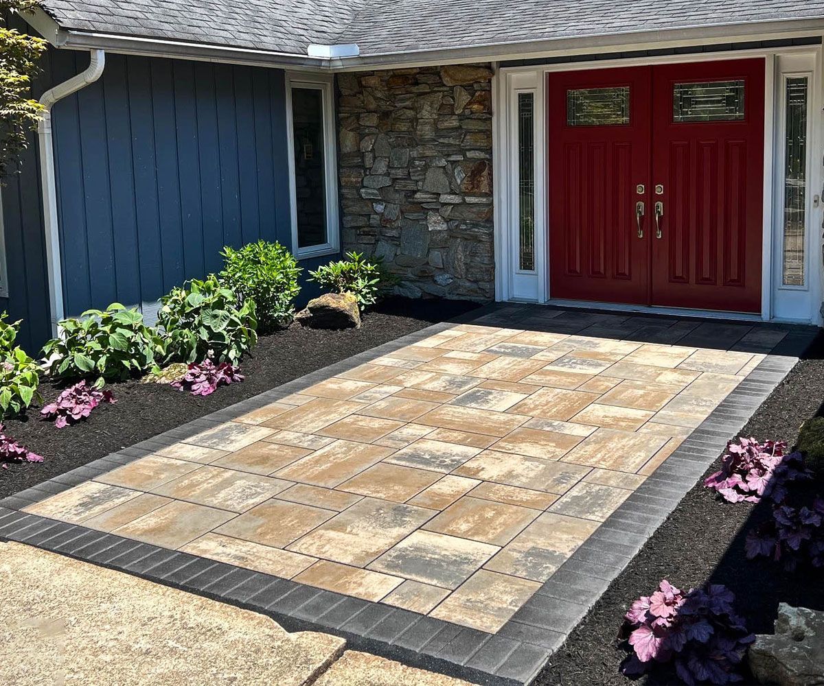 Northeast Ohio home front entrance with ashlar style Unilock paving stone walkway 