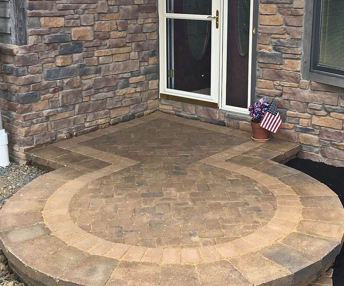 New home with front entrance made from paver stones in the shape of a circle with contrasting border in Cleveland area.