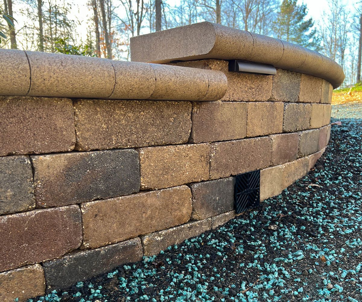 Bath, OH backyard retaining wall design and installation for sloped hill and drainage solution