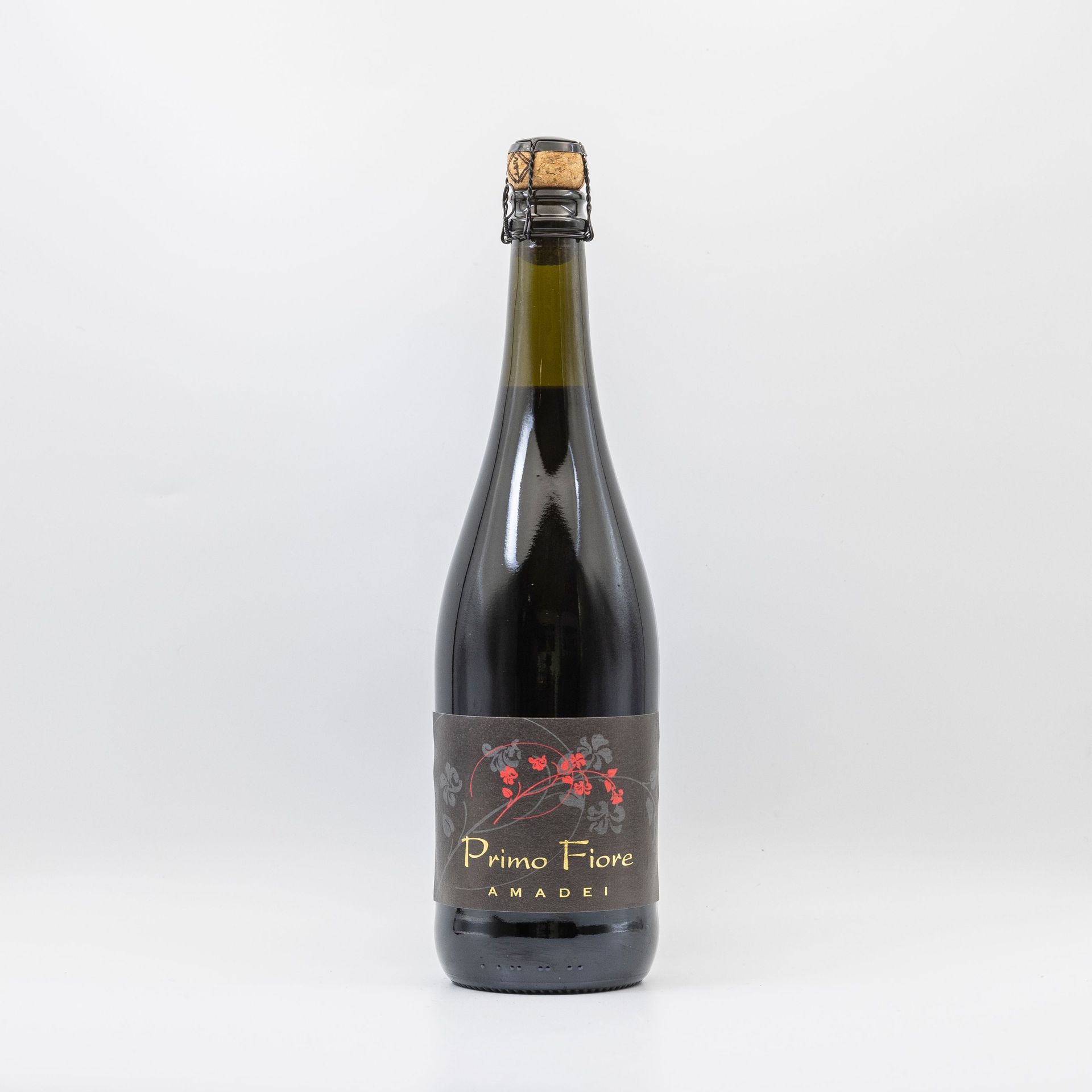 Bottle of dark sparkling wine with a black label and gold foil neck on a white background