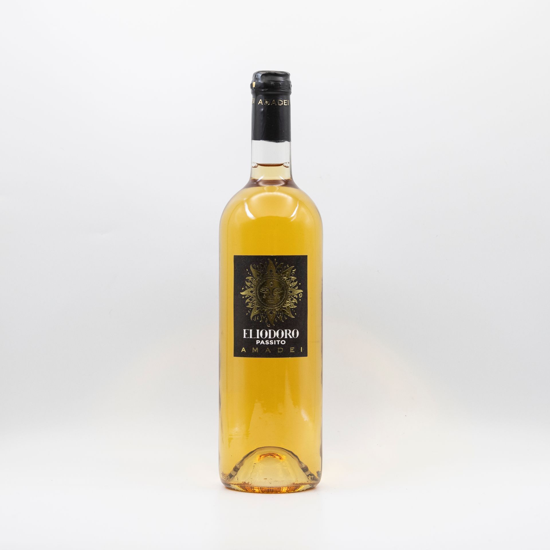 Tall amber liquor bottle with a black cap and dark label on a white background
