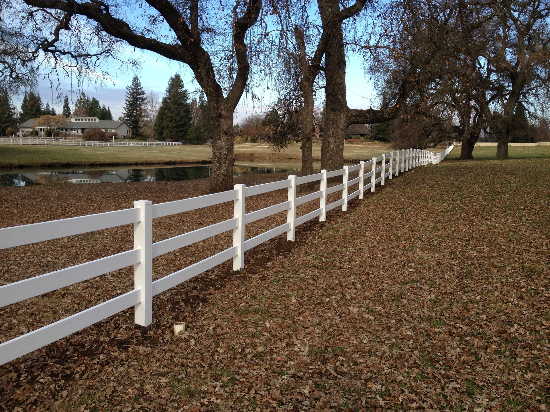 Wooden double gate with metal supports in a paved pathway.