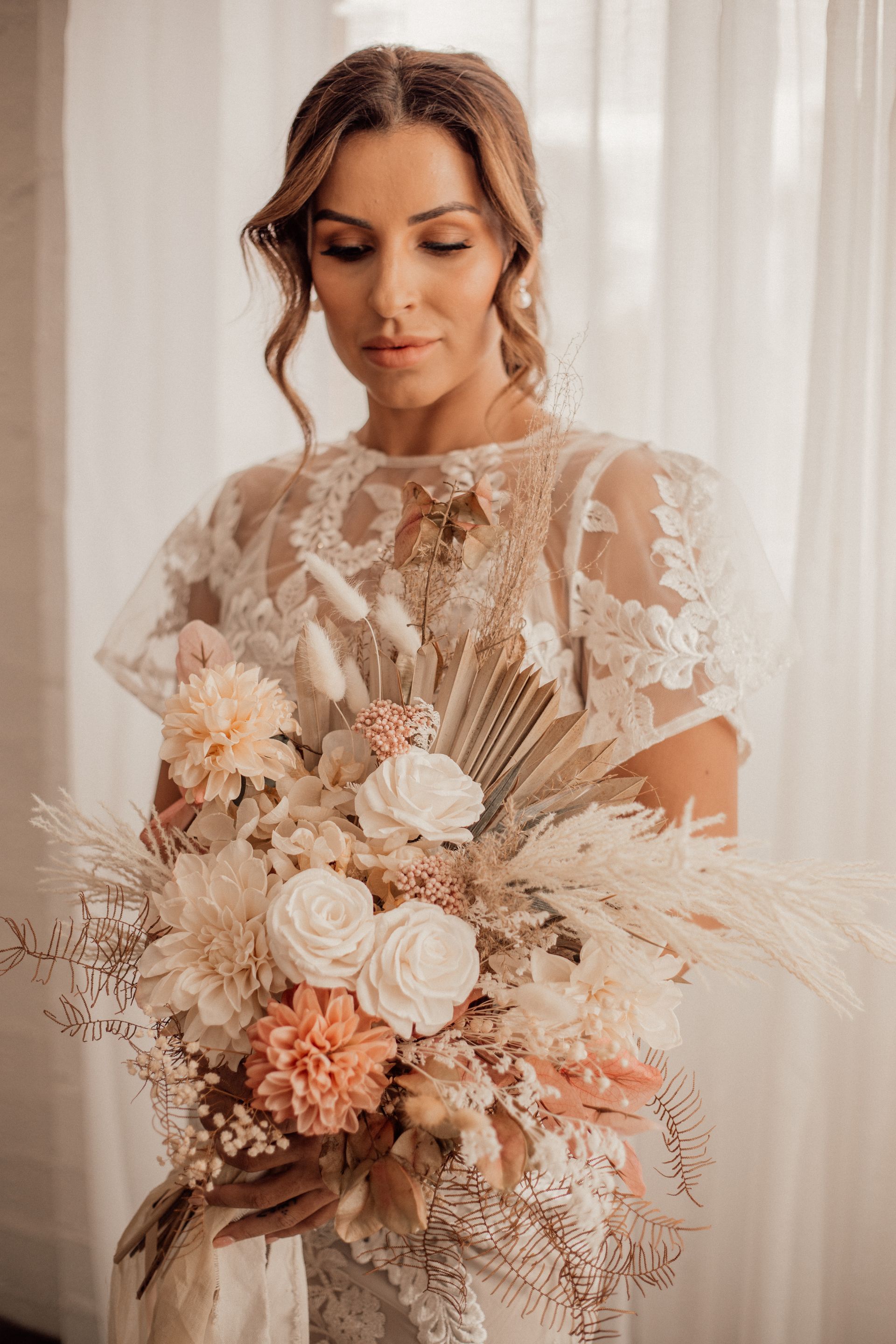 Woman in Lace Dress Holding a Bouquet of Dried Flowers — Denise's Flower Studio In Dubbo, NSW