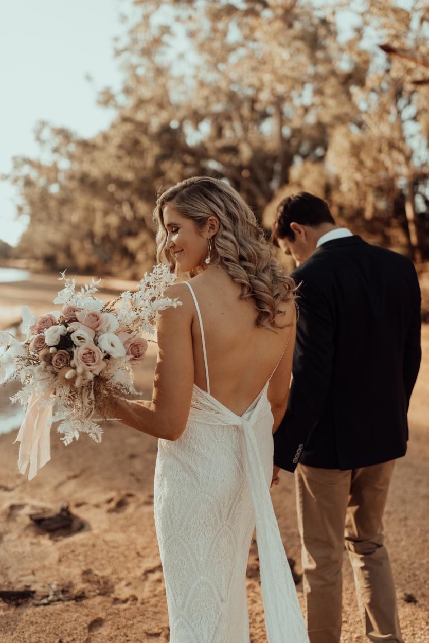 Bride in A Backless Dress Carries Bouquet — Denise's Flower Studio In Dubbo, NSW