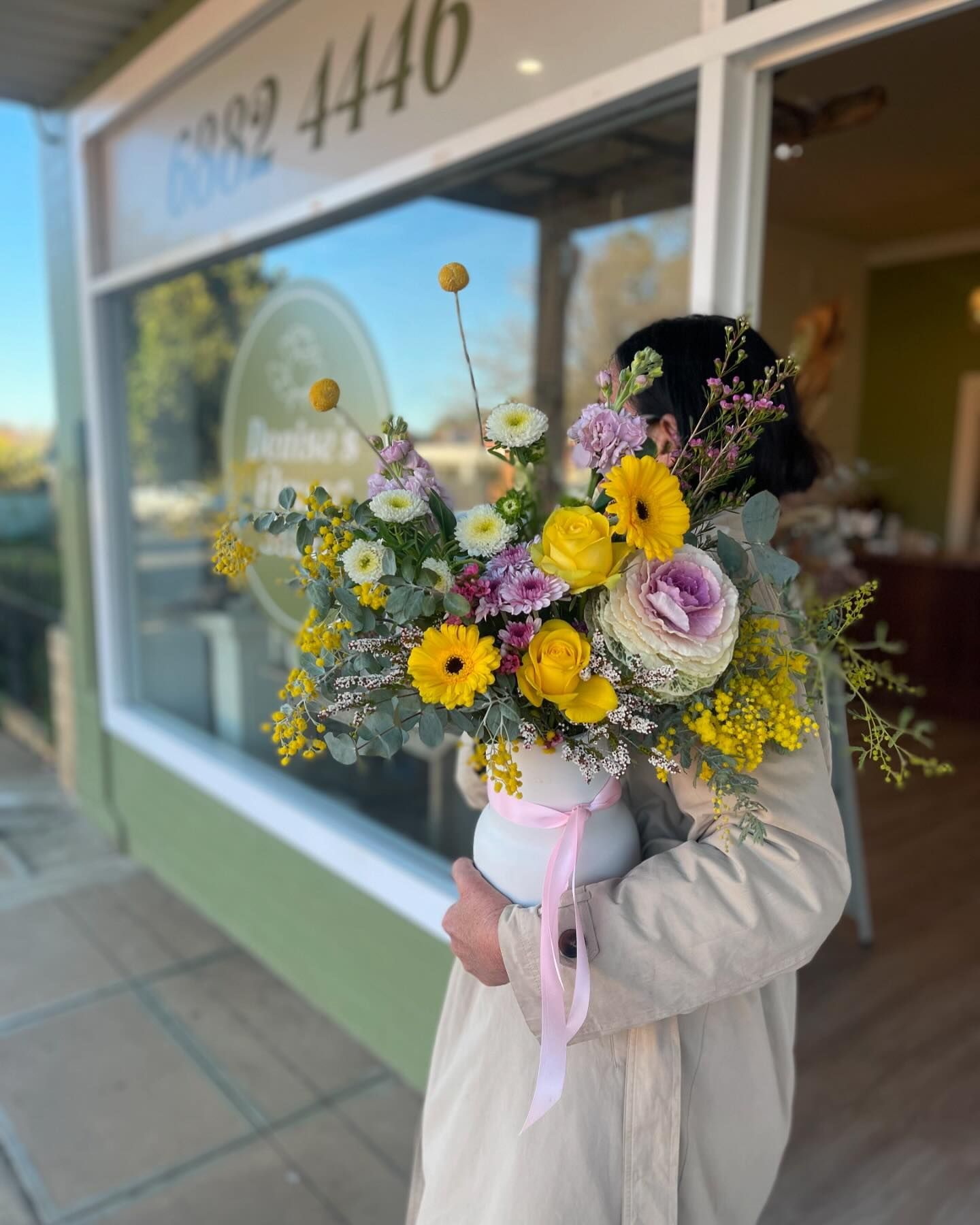 Person Holding a Large Bouquet of Flowers Outside a Storefront — Denise's Flower Studio In Coonamble, NSW