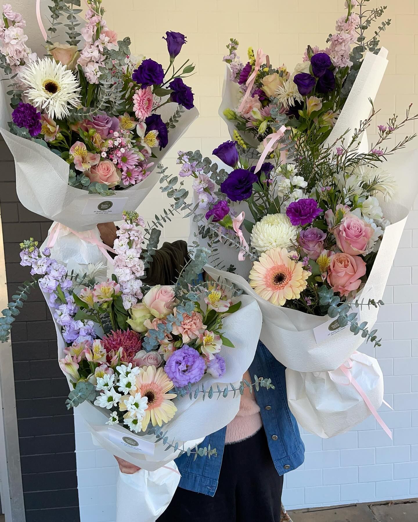 Person Holding Three Large Bouquets of Pastel and Purple Flowers — Denise's Flower Studio In Dubbo, NSW