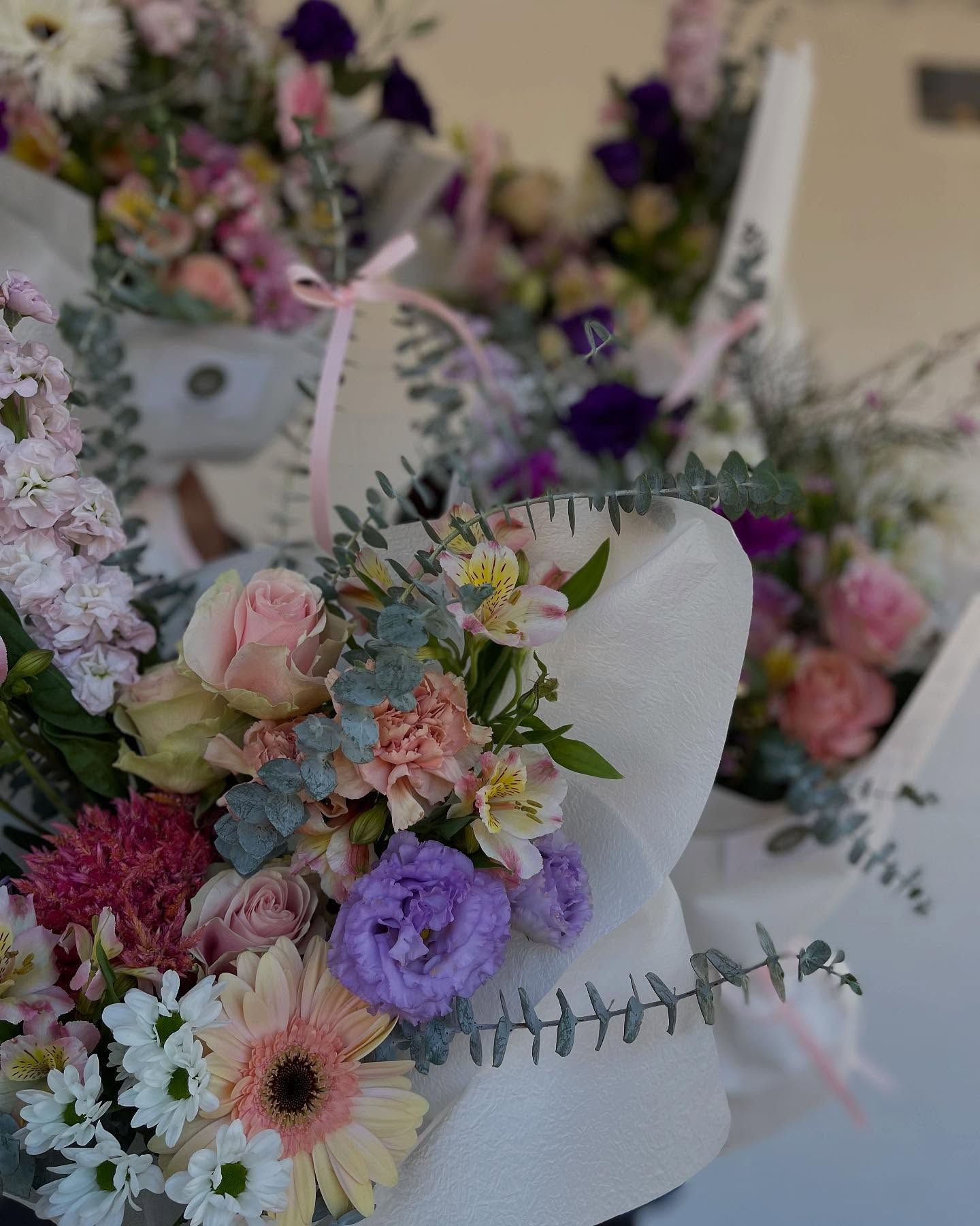 Pastel Floral Bouquet with Daisies, Roses, and Purple Blooms in A White Vase — Denise's Flower Studio In Walgett, NSW