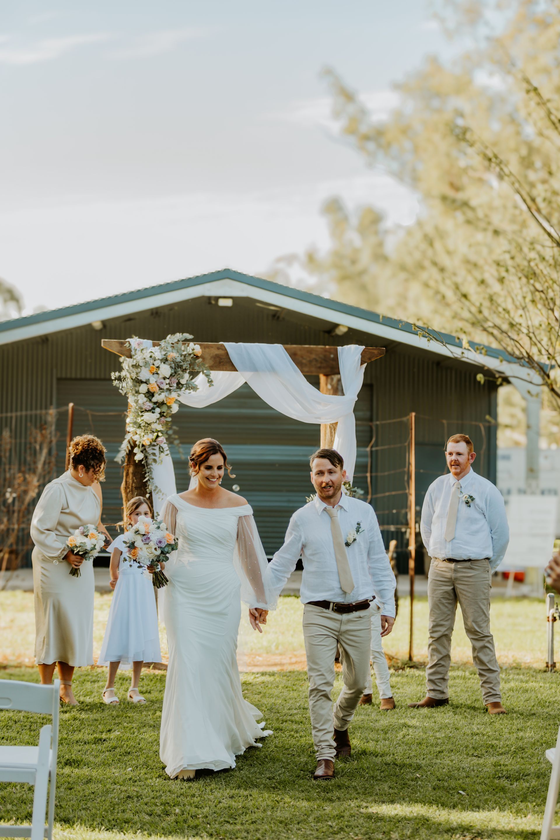 Newly Married Couple Holding Hands — Denise's Flower Studio In Dubbo, NSW