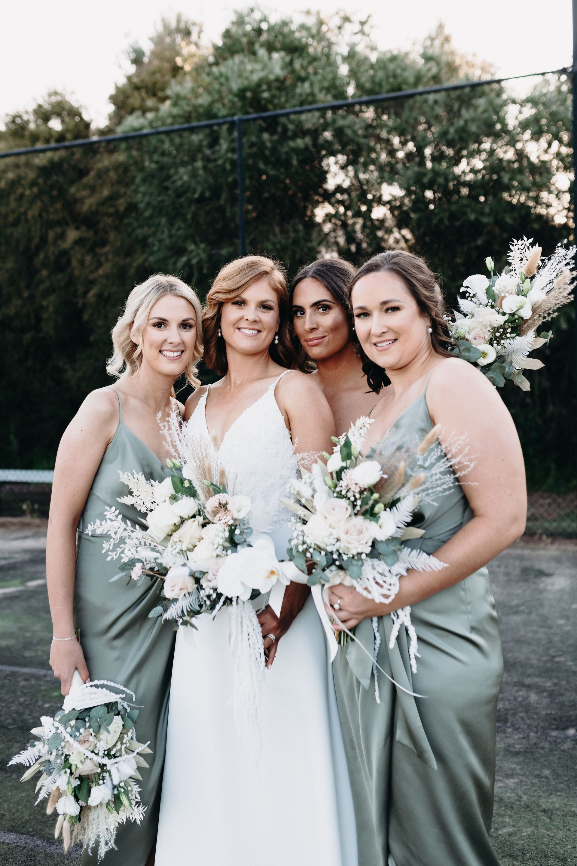 Bride with Bridesmaids Dressed in White and Sage Green Dresses — Denise's Flower Studio In Dubbo, NSW