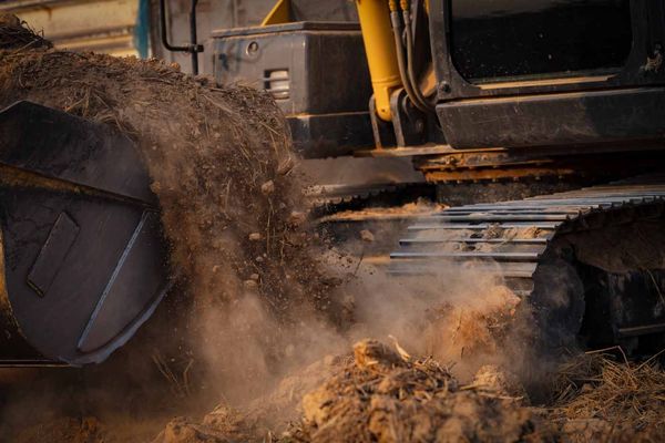 A bulldozer is digging a hole in the ground at a construction site.