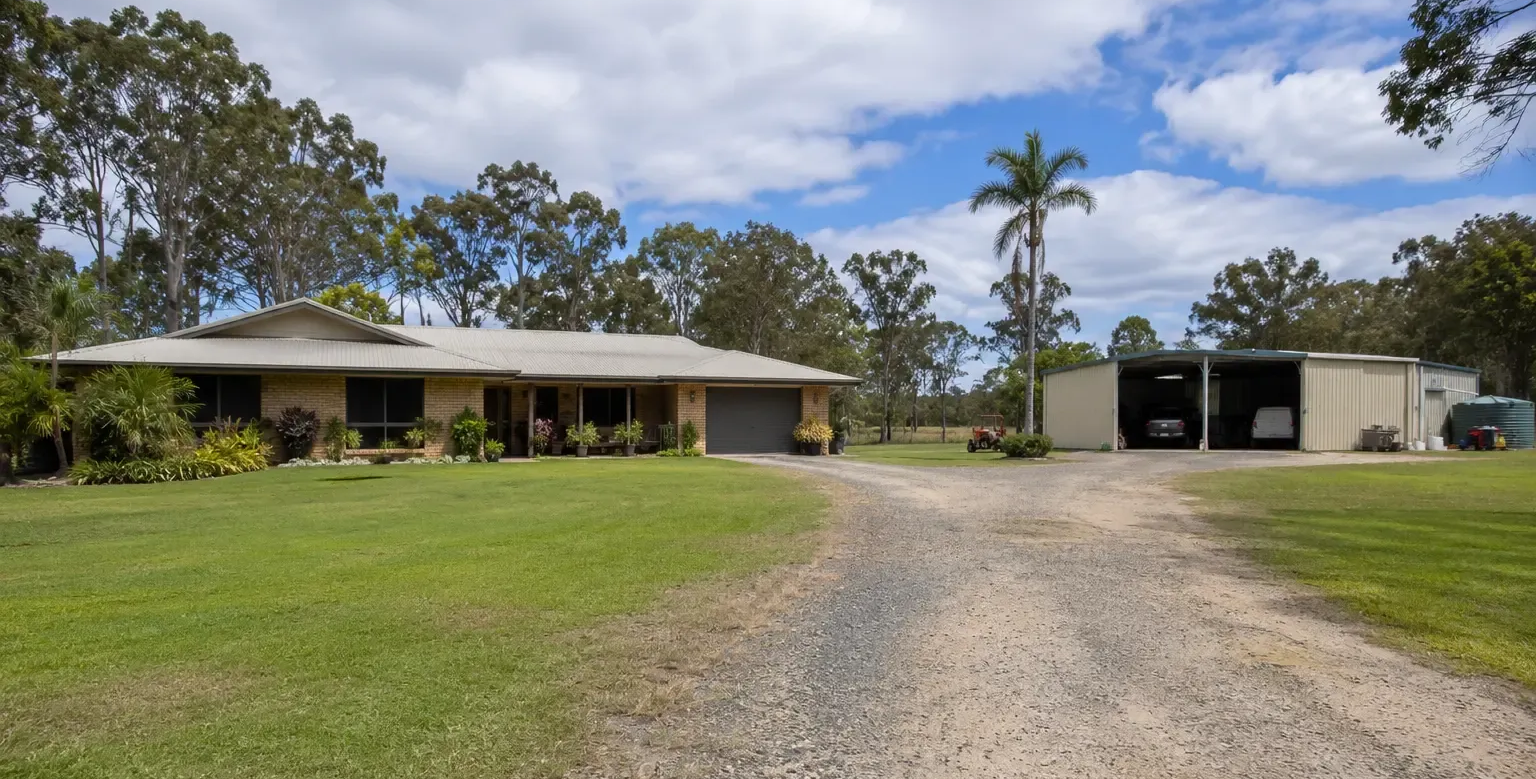 Subtle surface grading to keep water from the driveway and shed entry. Rural property near Avondale, north of Bundaberg.