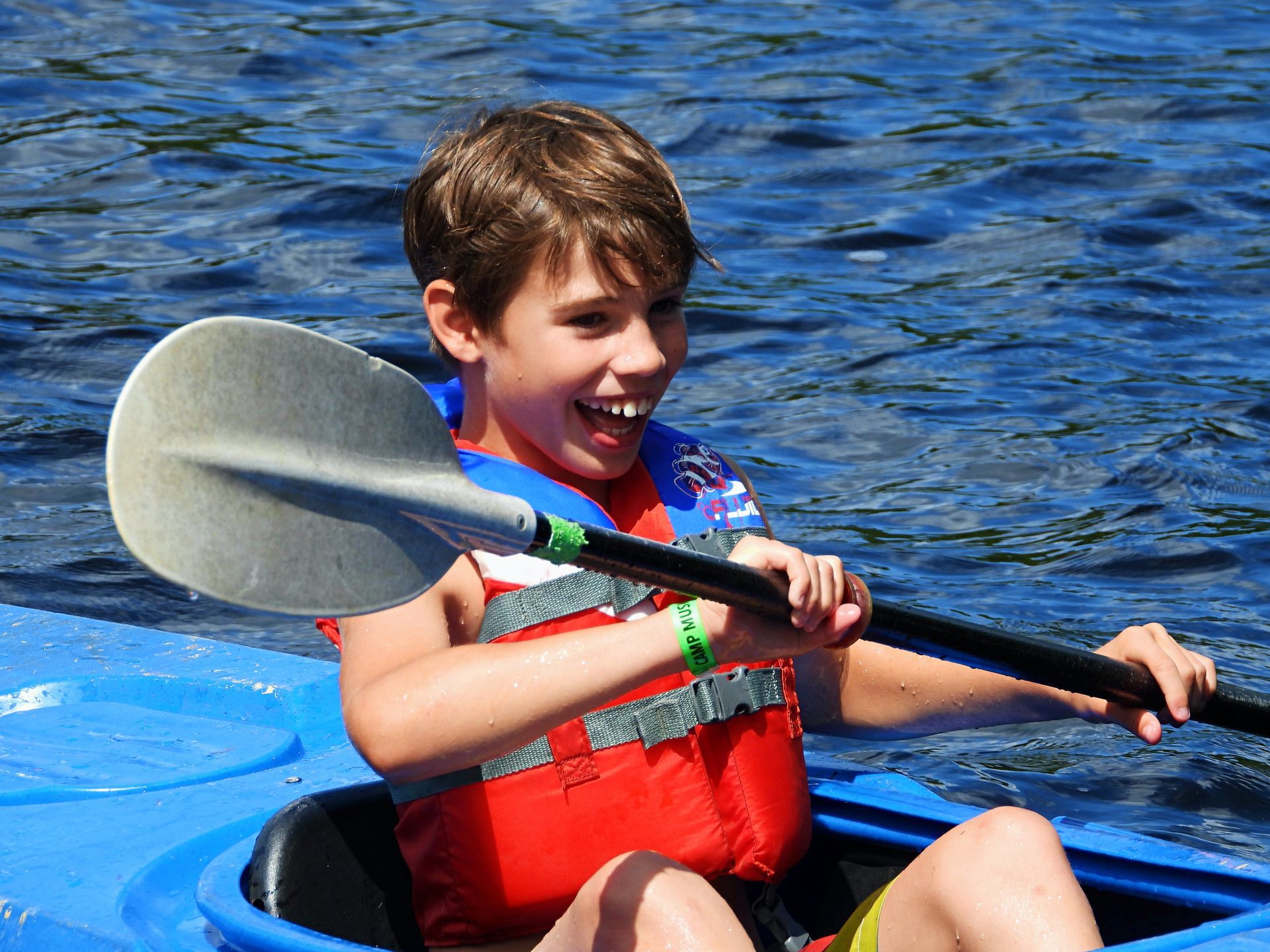 A boy kayaking on beautiful Cougar Lake