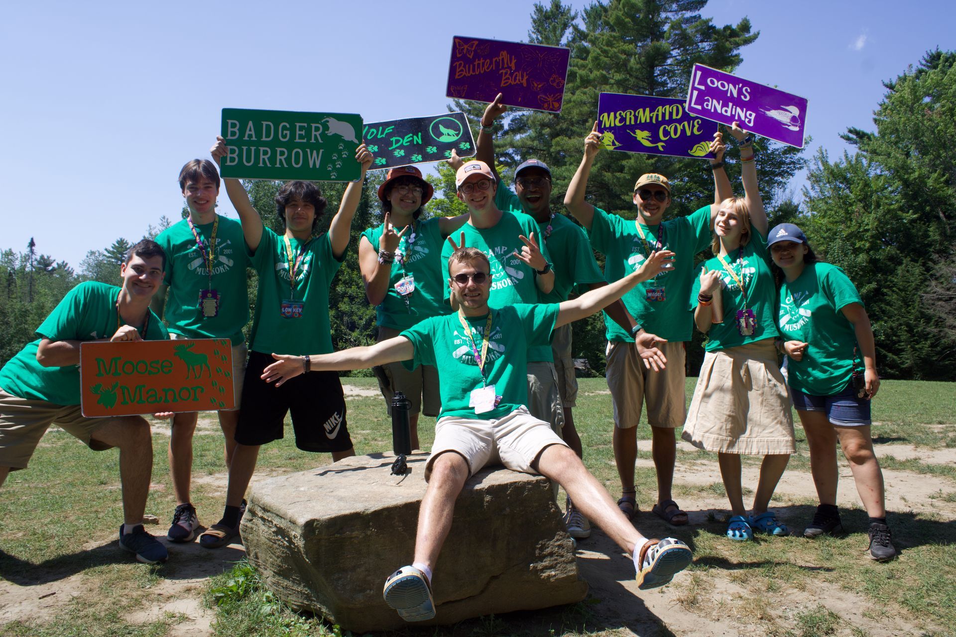 A group of people holding signs that say badger burrow