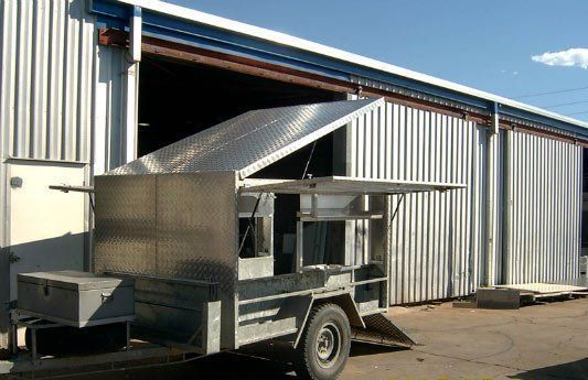 A trailer is parked in front of a building — Dalrymple Sheet Metal In Garbutt, QLD
