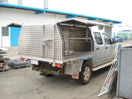 A Silver Truck With A Canopy Is Parked In Front Of A Building — Dalrymple Sheet Metal In Garbutt, QLD