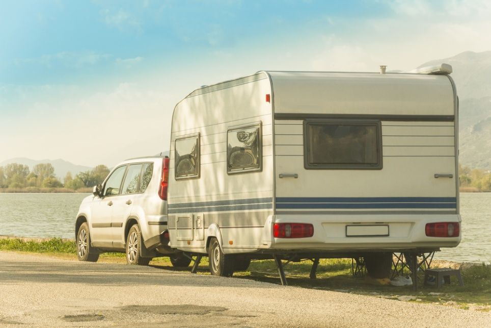 A Car is Towing a Caravan on the Side of the Road — Chilltech Air Conditioning & Refrigeration In Capricorn Coast, QLD