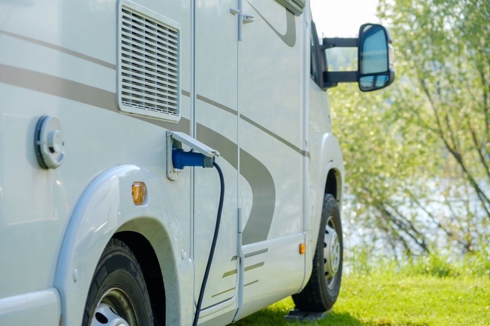 A Caravan is Plugged Into a Charger on the Side of It — Chilltech Air Conditioning & Refrigeration In Rockyview, QLD