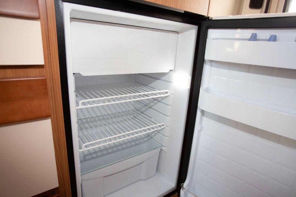 An Empty Refrigerator With the Door Open in a Kitchen — Chilltech Air Conditioning & Refrigeration In Rockyview, QLD