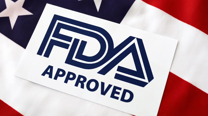 A fda approved sticker is sitting on top of an american flag.