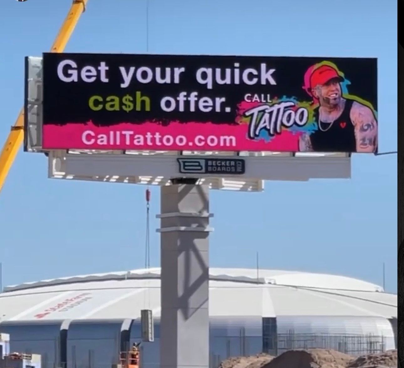 Billboard ad for CallTattoo.com with “Get your quick cash offer” and a tattooed man on a blue sky background