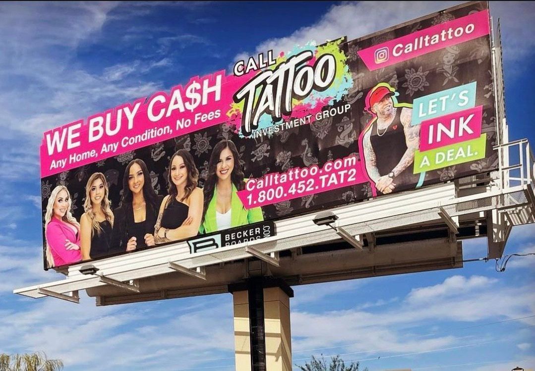 Billboard for Tinto cash-for-cars and ink deal ads against a blue sky