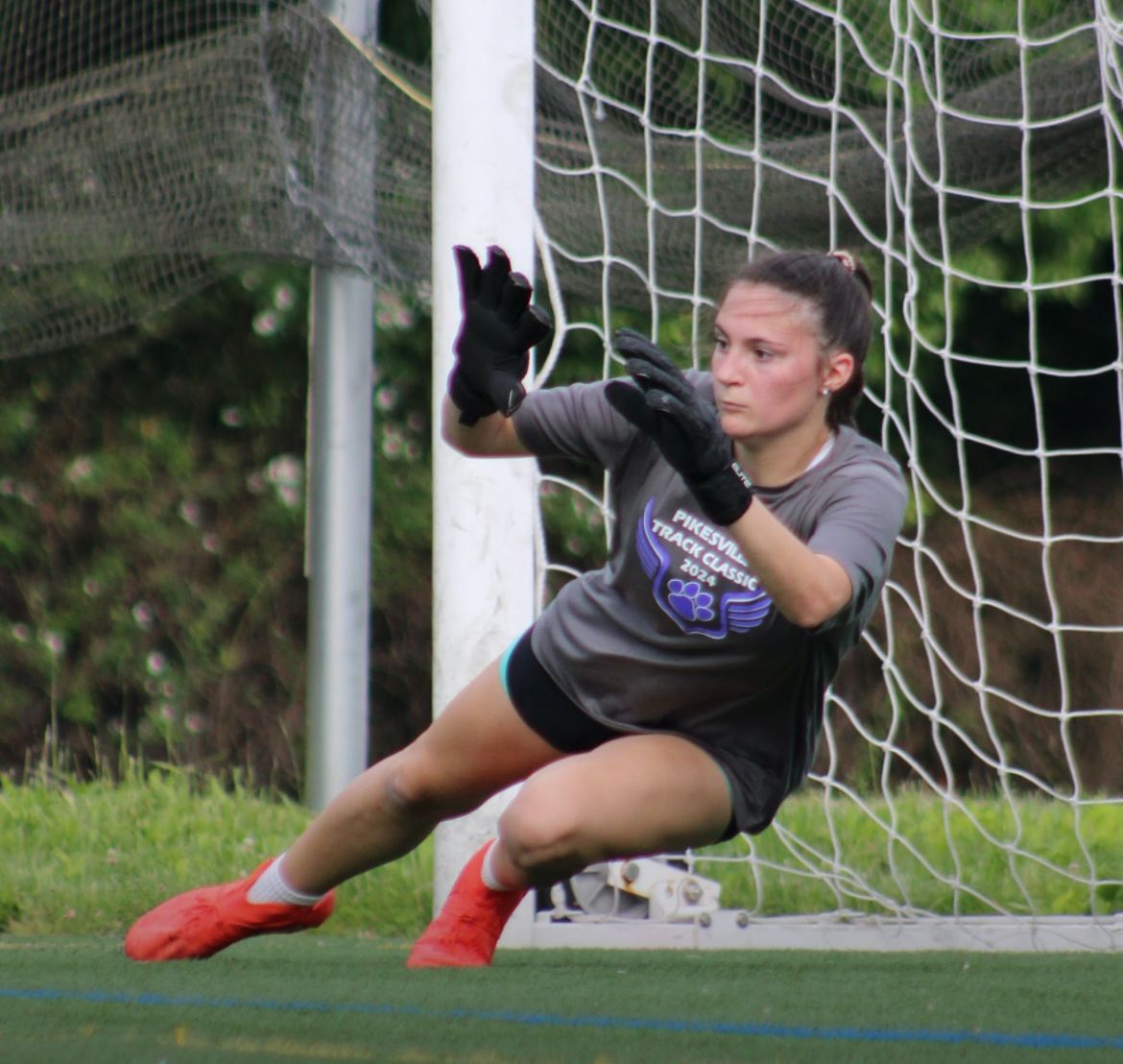PYN female goalkeeper diving to save ball