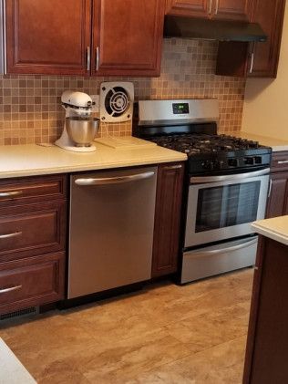A kitchen with stainless steel appliances and wooden cabinets