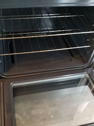 A close up of the inside of an oven with the door open.