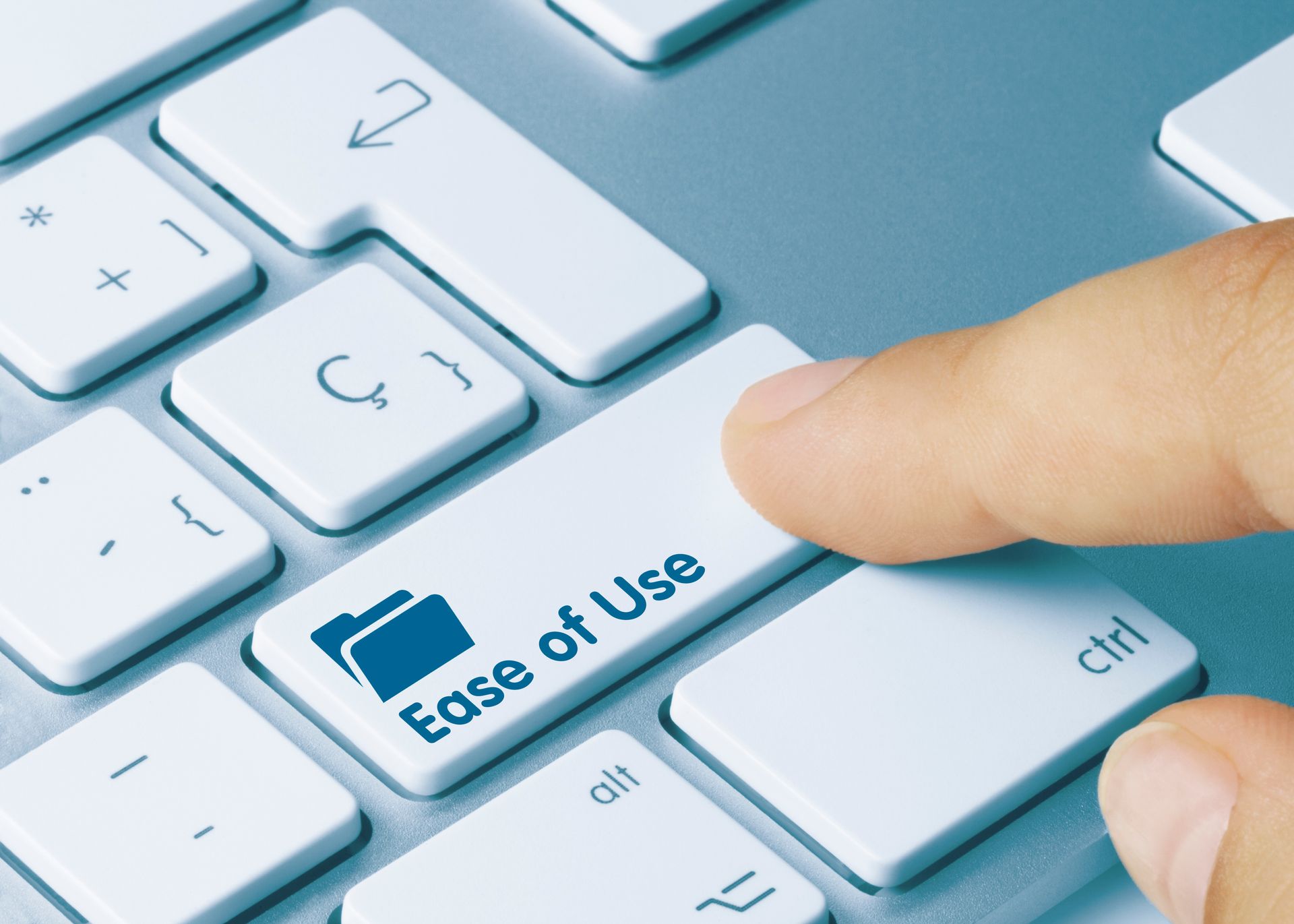 Finger pressing keyboard key labeled “Ease of Use”
