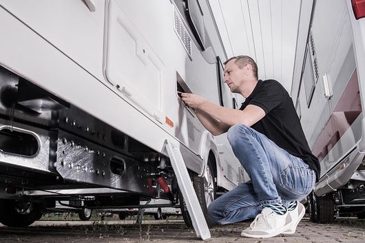 man working on rv