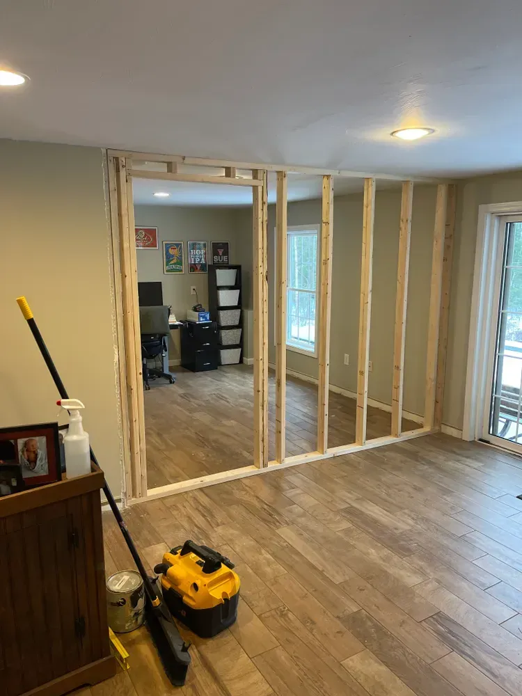 A room with a mop and a vacuum cleaner in it.