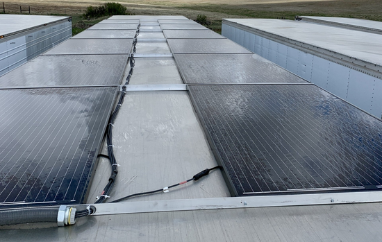 Damaged rooftop skylight panels with a large crack down the center, viewed from above.