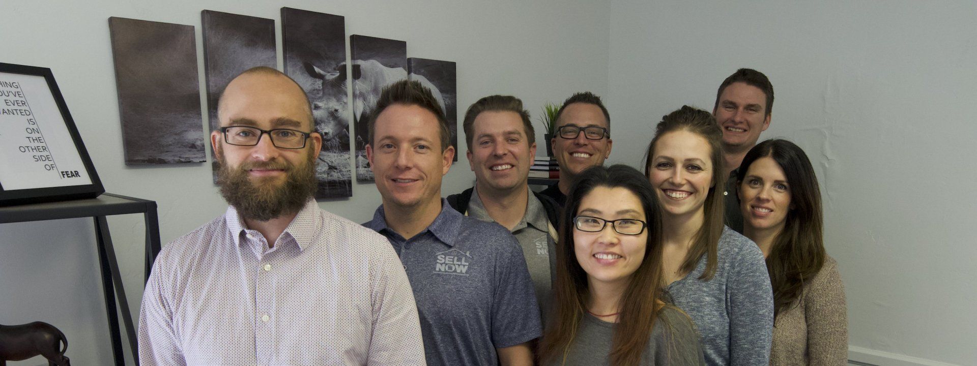 A group of people are posing for a picture in a room.