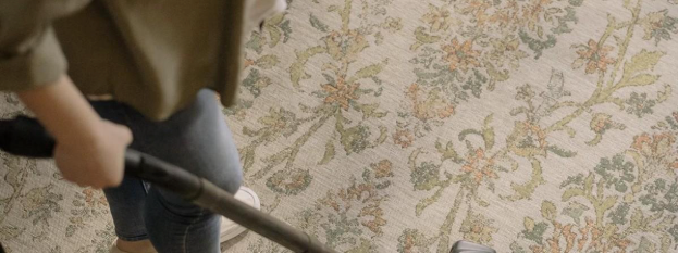 Overhead view of a patterned carpet being cleaned with a wand during carpet cleaner service in Mill 
