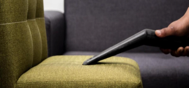 Upholstery tool drawn across a fabric sofa cushion by a professional upholstery cleaner in Novato
