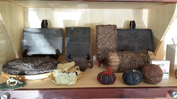 Shelves with woven baskets, placemats, and decorative fabric-covered balls in neutral and earthy tones